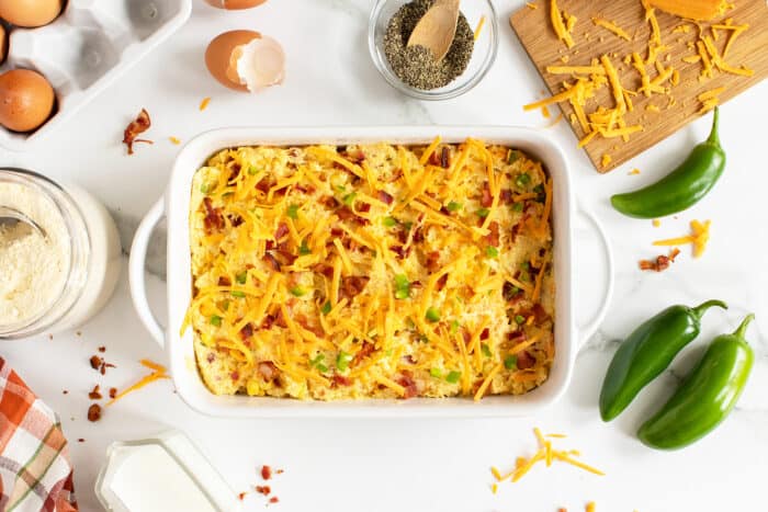 cornbread casserole overhead view with ingredients around the pan