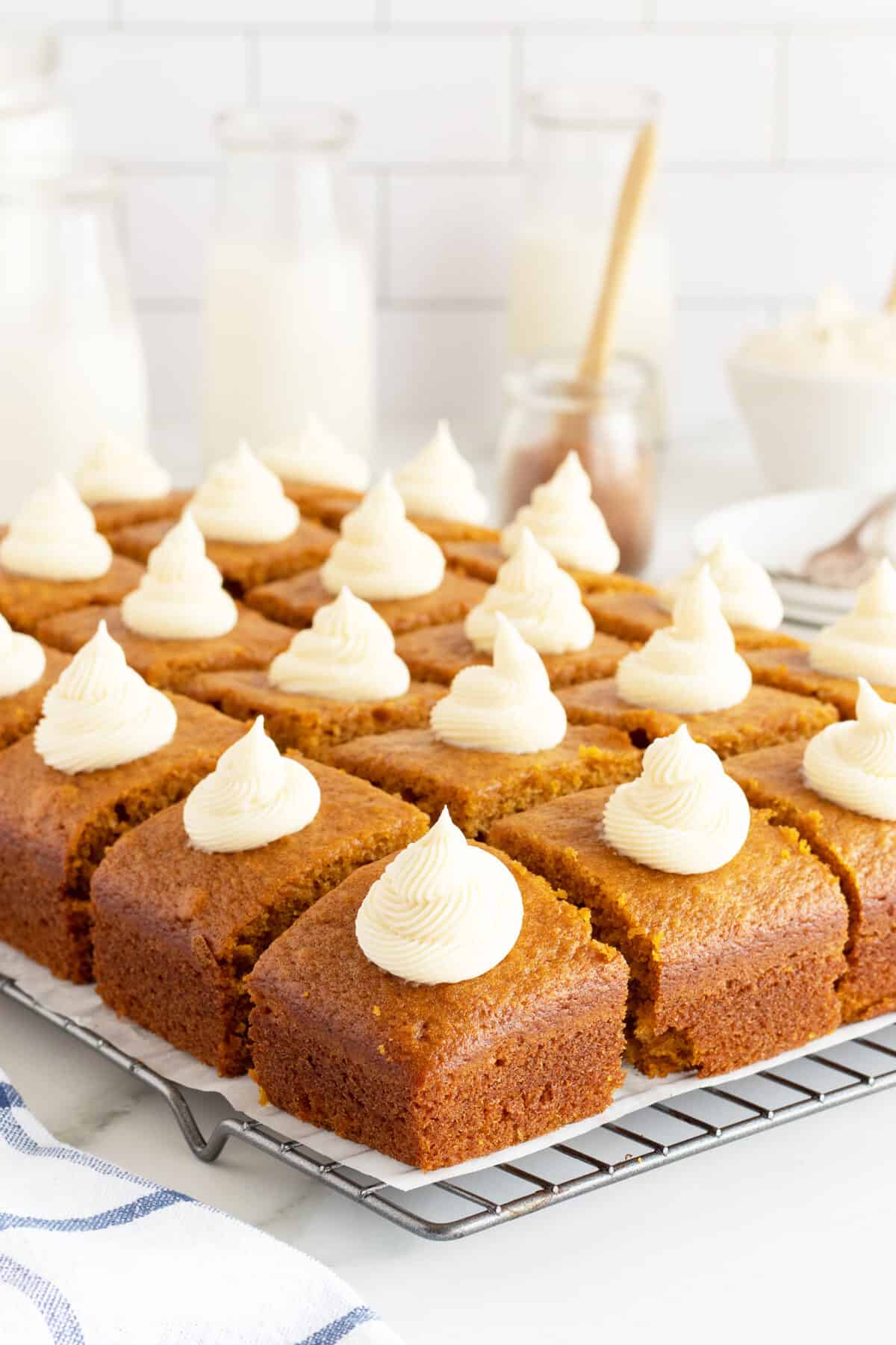 Pumpkin Cake sliced with a dollop of icing on each square