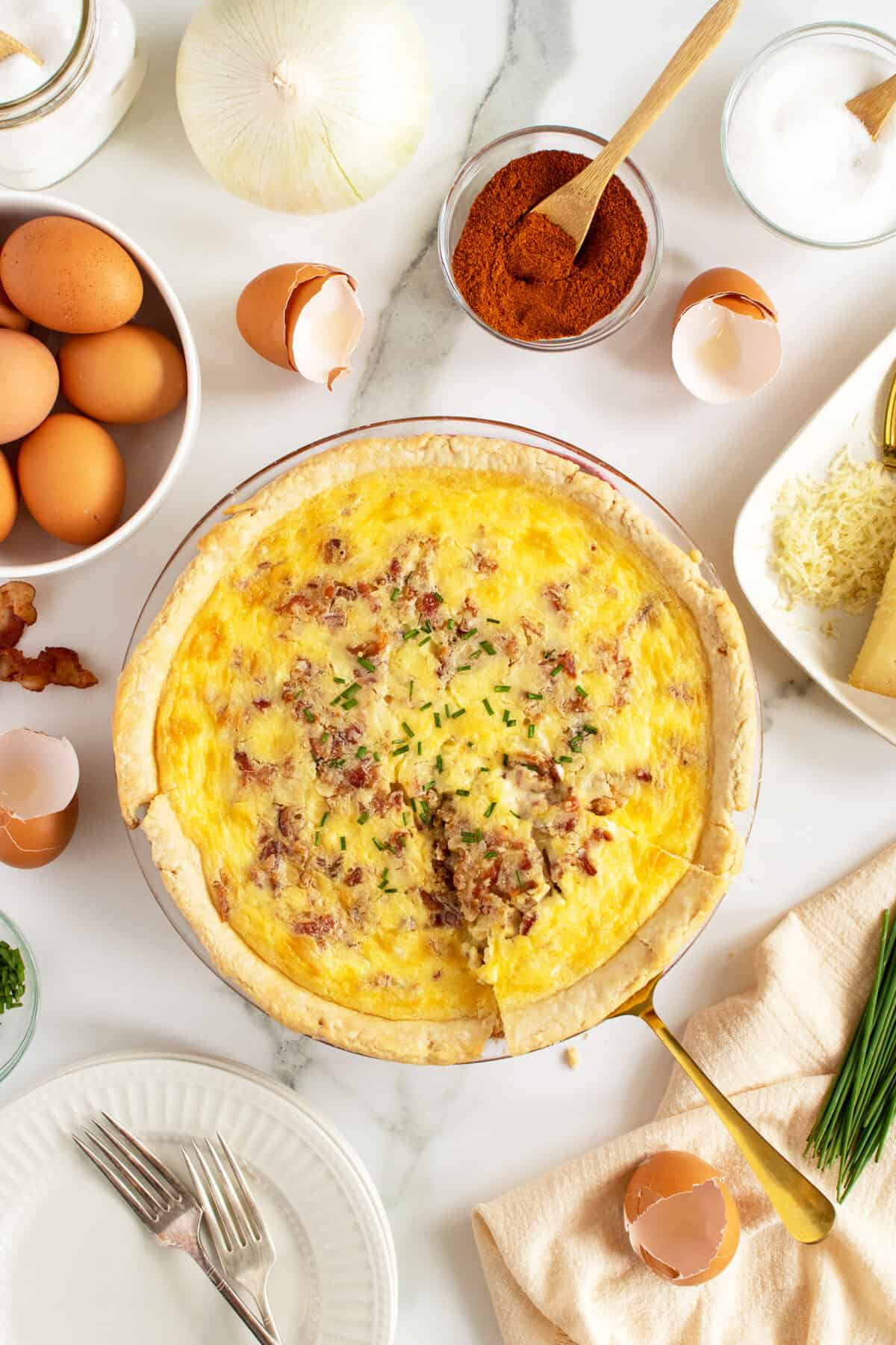 quiche lorraine with slice being lifted out of pan