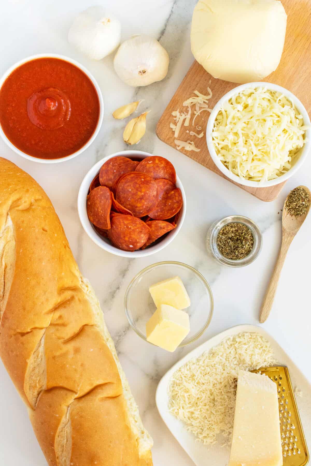 French Bread Pizza ingredients in small white bowls