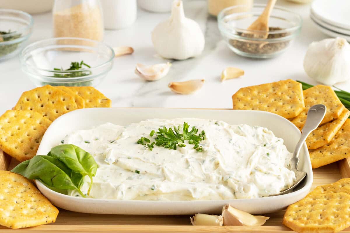 whipped cream cheese on a platter with crackers around