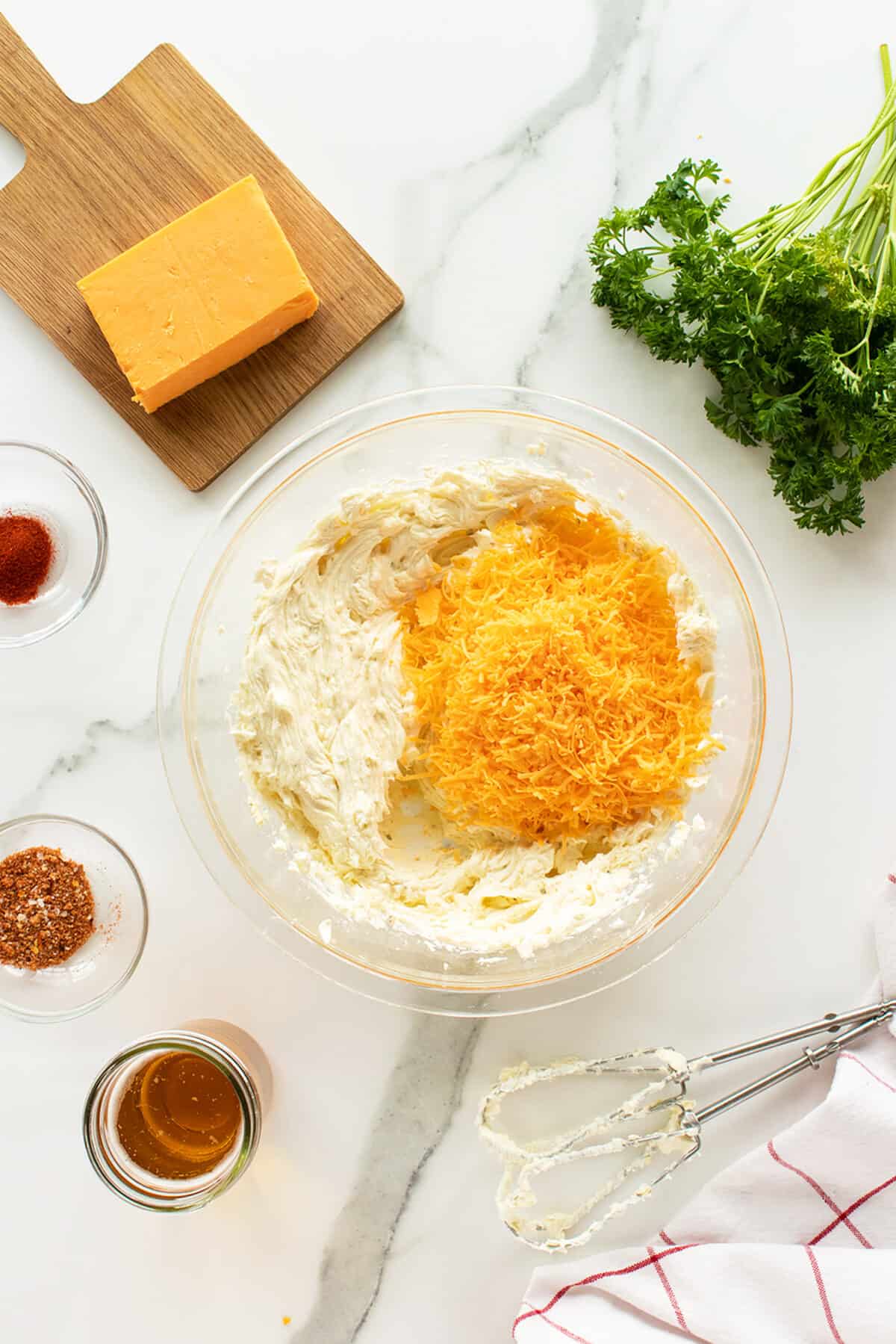 beer cheese dip mixing in the grated cheese to the cream cheese in a large bowl