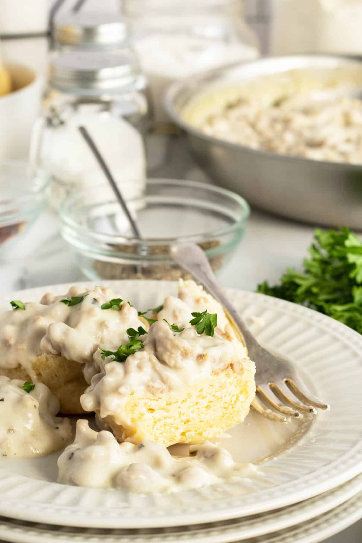 biscuits & gravy on a plate with a fork