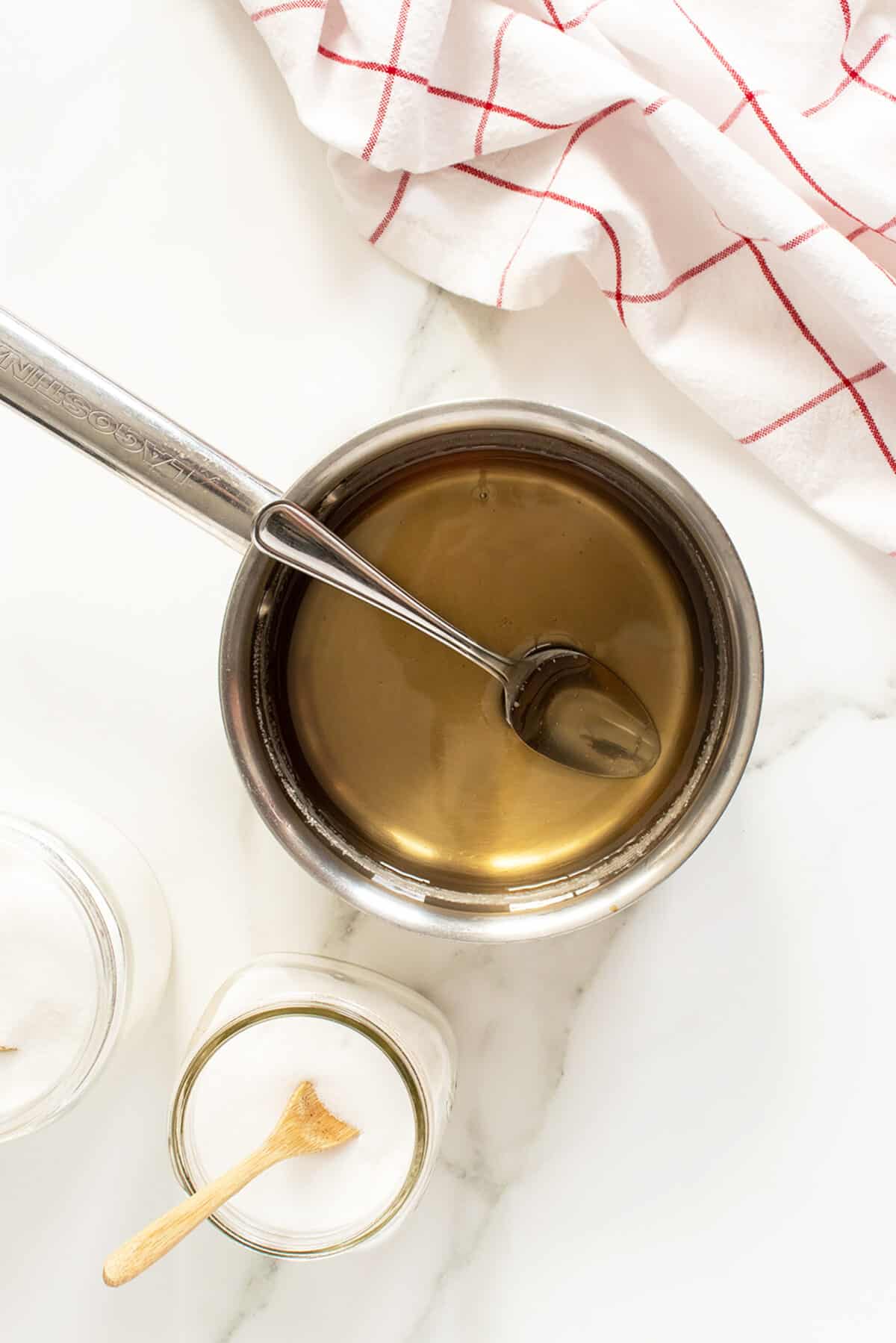 caramel syrupin a pot with a spoon