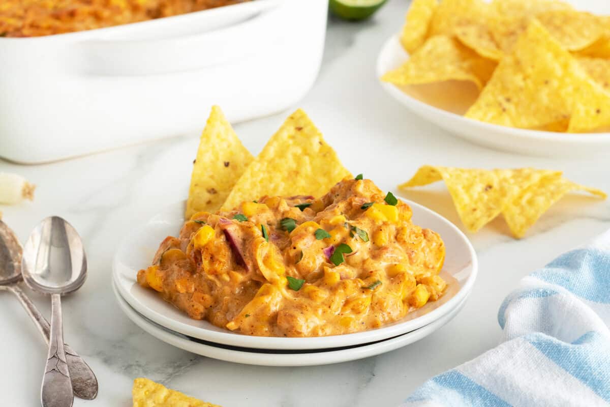 Corn Dip on a white plate with corn chips