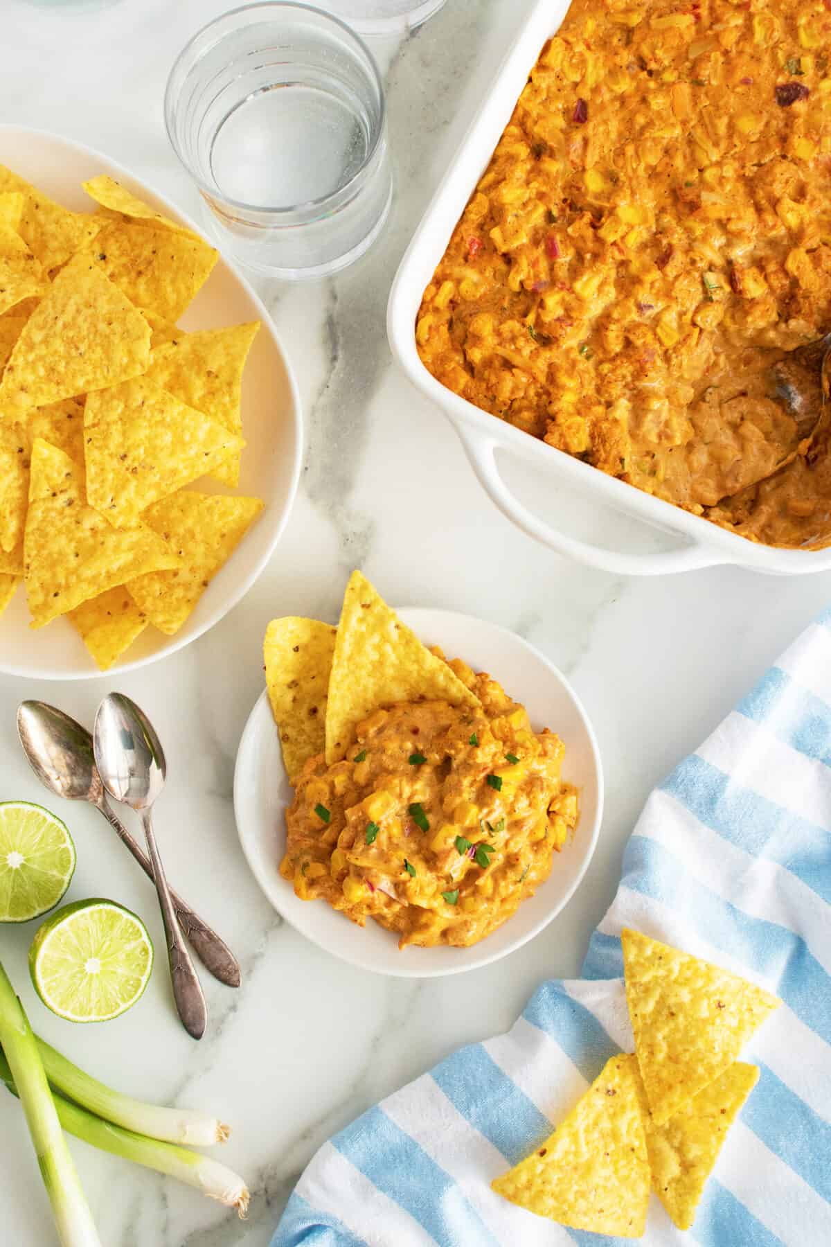 Corn Dip on a plate with a bowl of corn chips