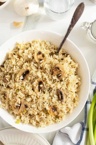 mushroom rice in a large bowl with a spoon