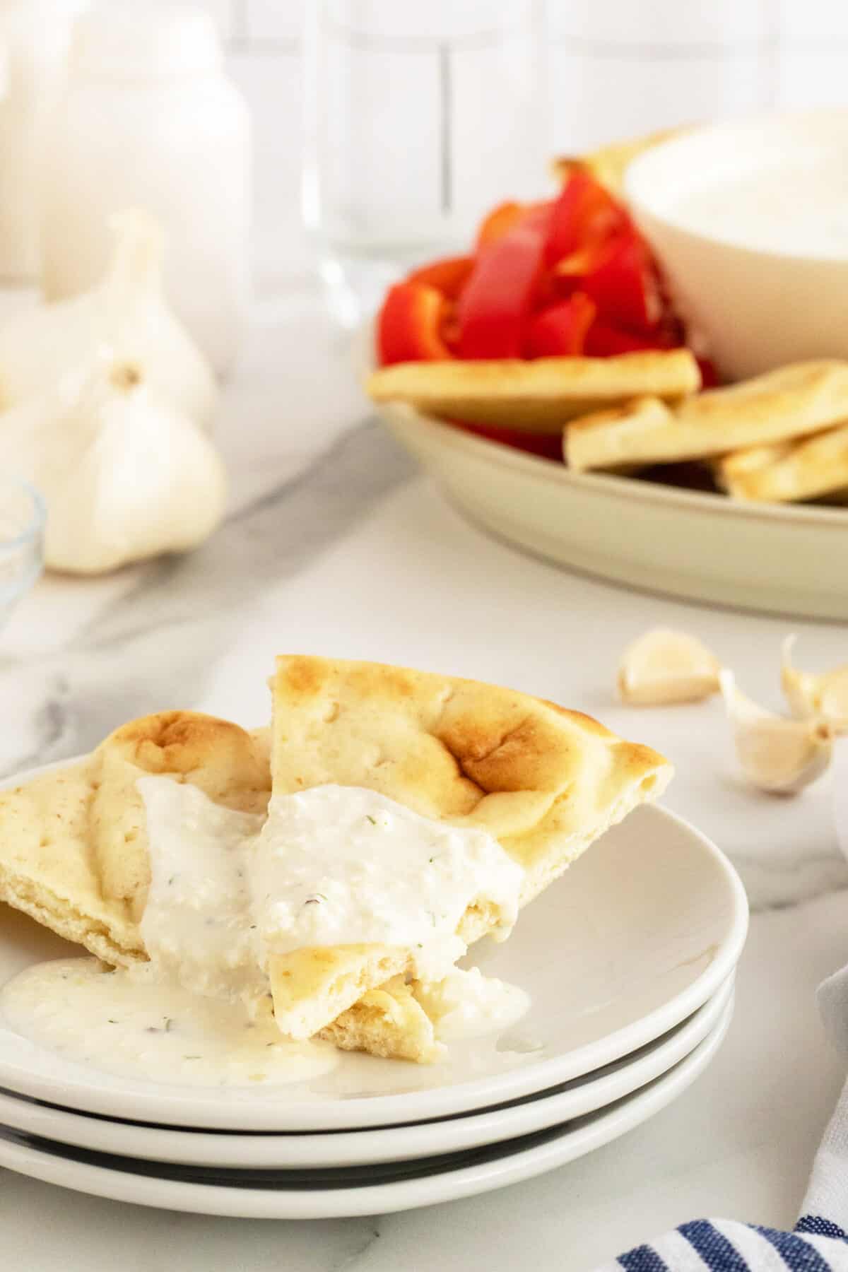 Whipped Feta Dip on pita slices on a plate