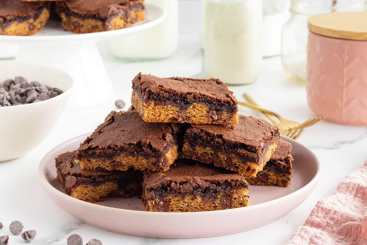 Brownie cookies stacked on a light pink plate