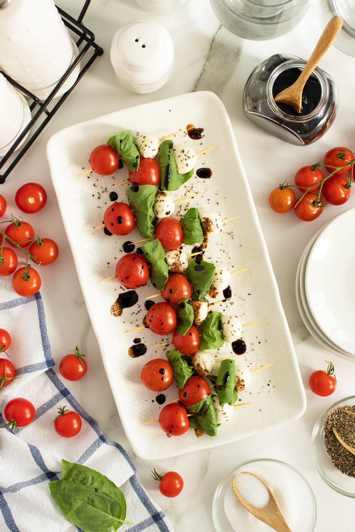 caprese skewers on a white platter