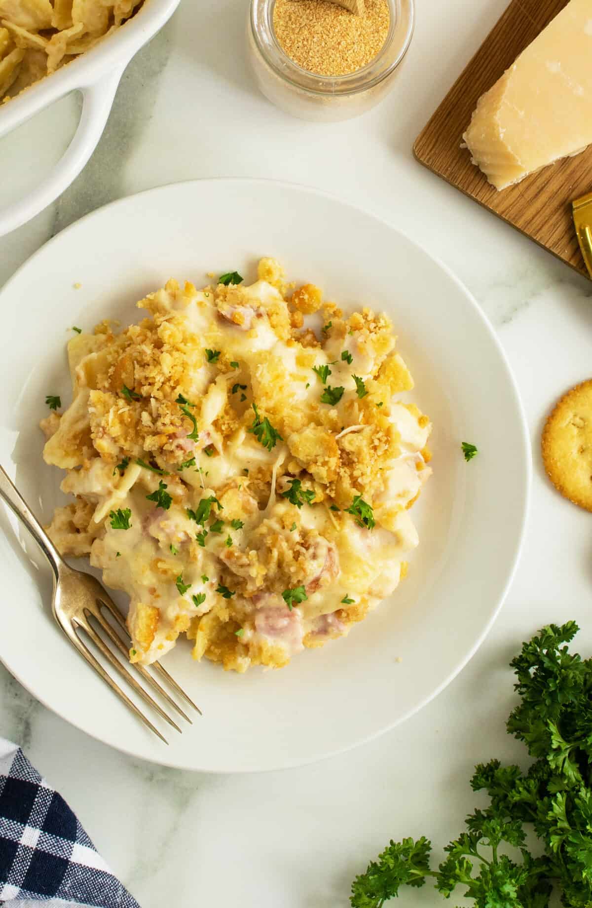 chicken cordon bleu casserole on a white plate with a fork