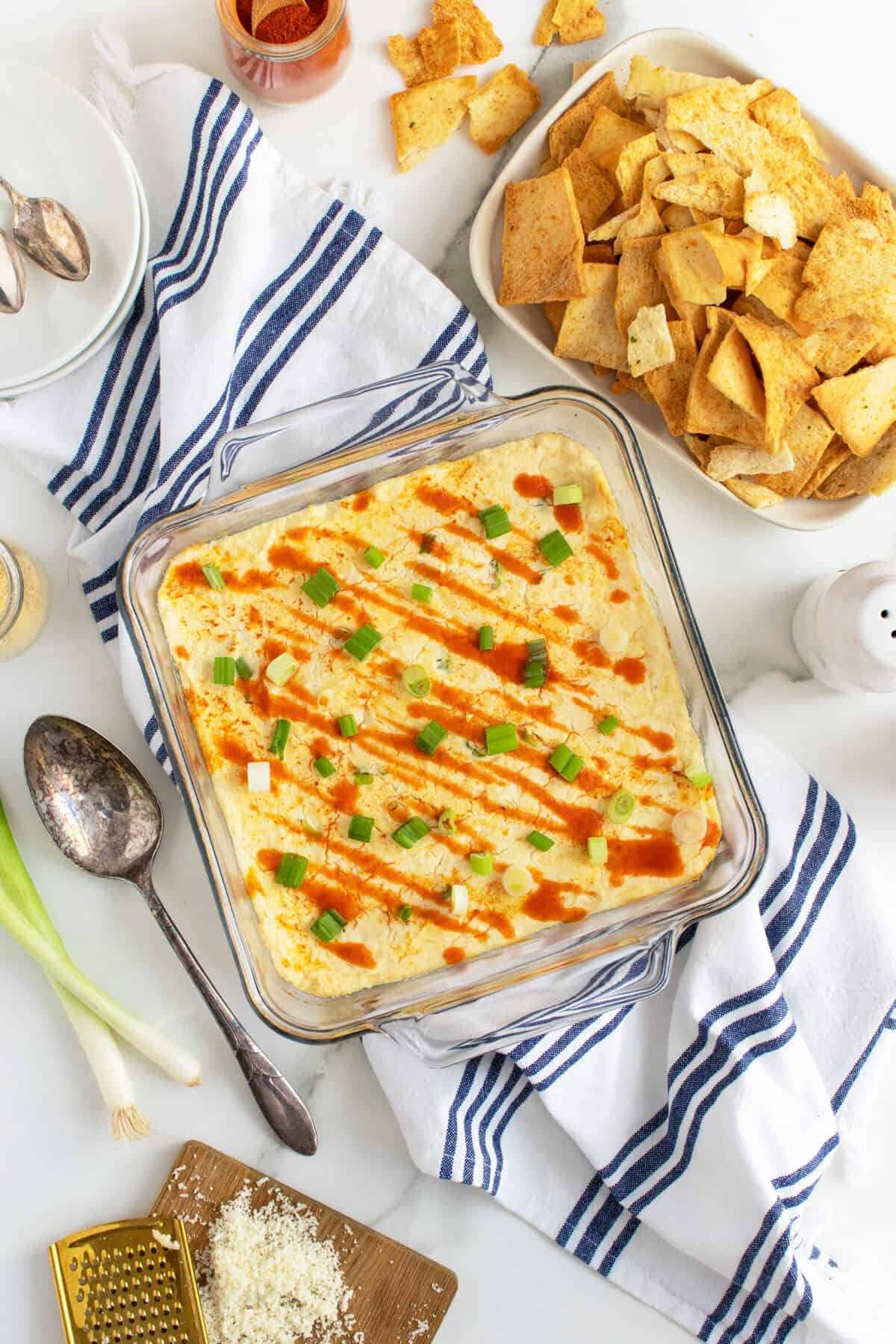 crab rangoon in a square clear baking dish with toppings