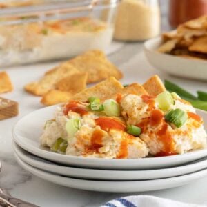 crab rangoon on a stack of white serving plates