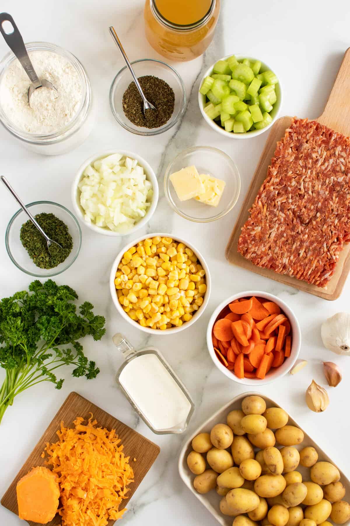 creamy sausage potato soup ingredients in small white bowls