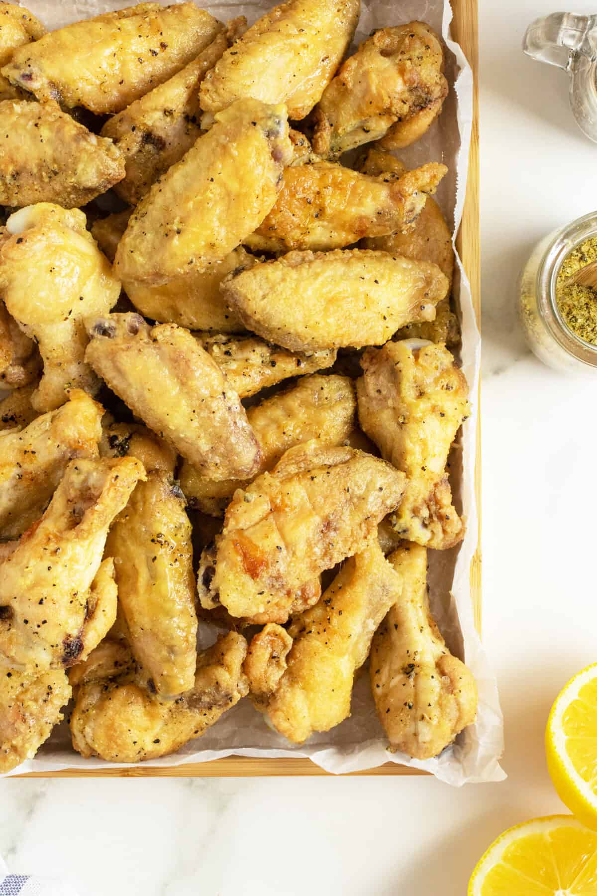 lemon pepper wings on a baking tray closeup