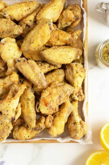 lemon pepper wings on a baking tray closeup