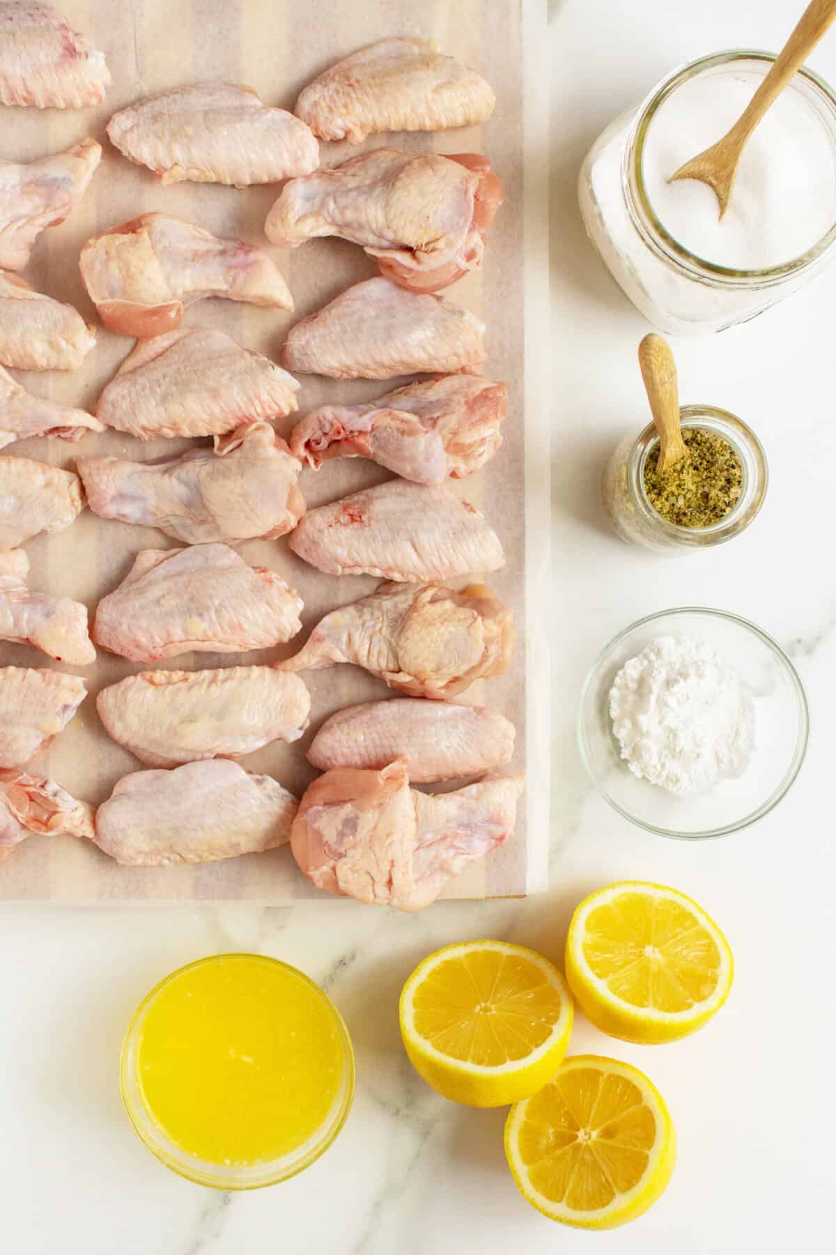 lemon pepper wings ingredients on a wooden cutting board