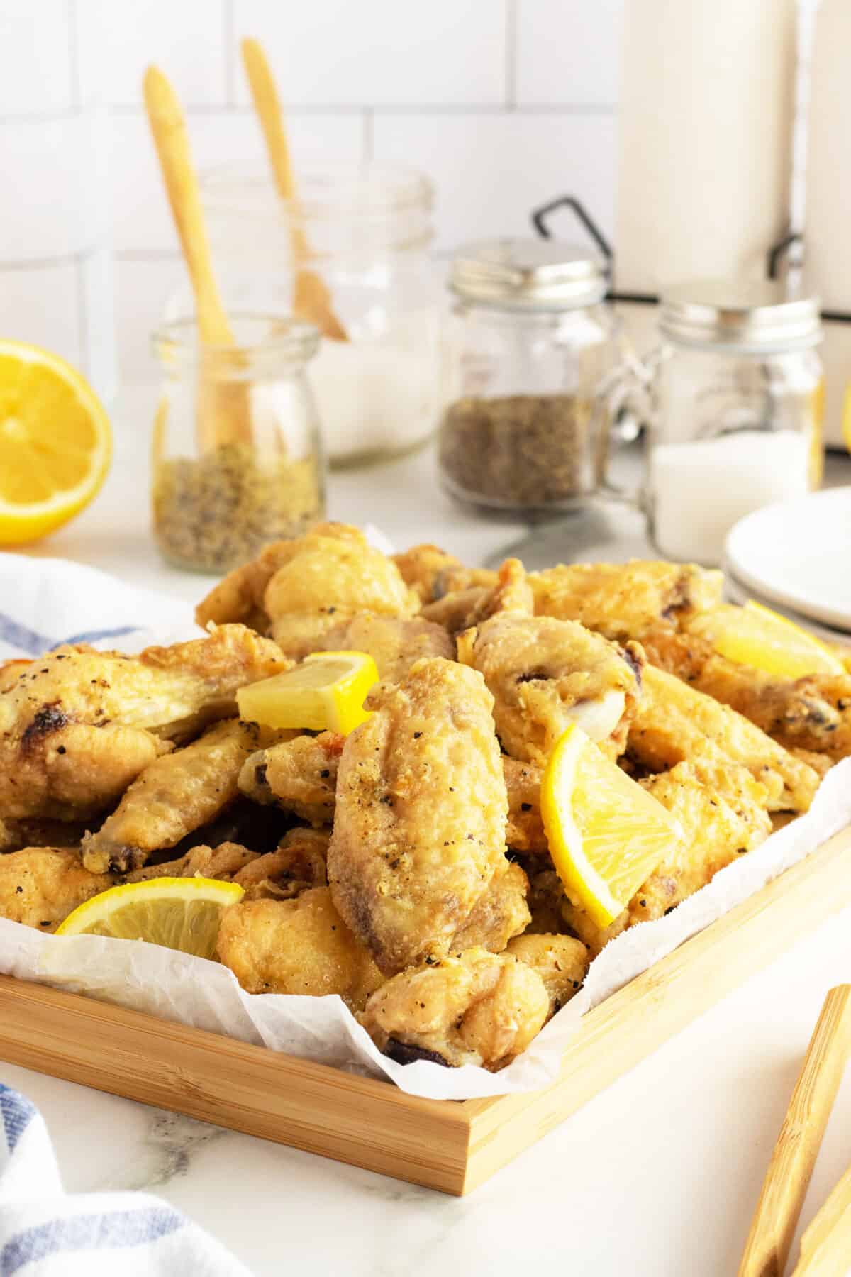 lemon pepper wings on a baking tray with parchment