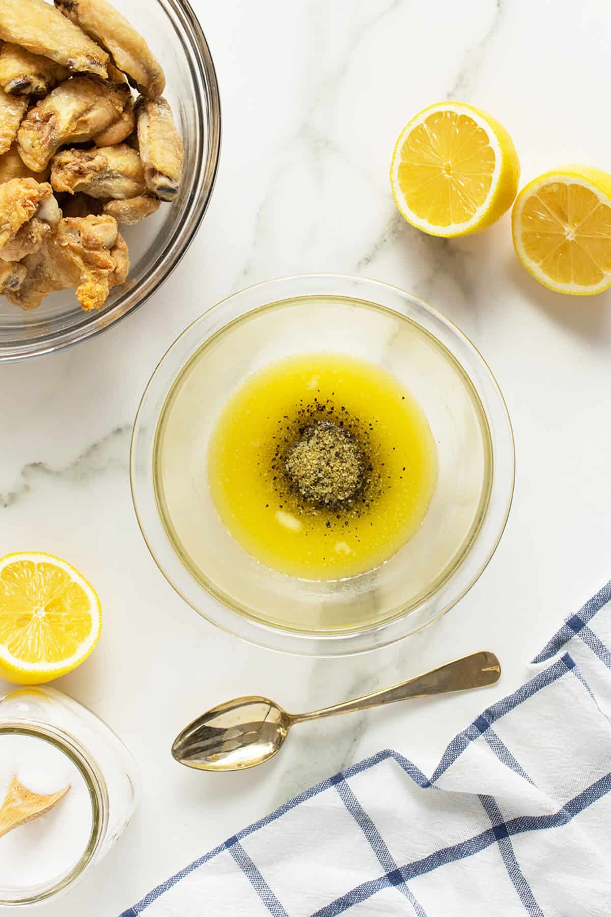 lemon pepper wings butter sauce in a clear bowl