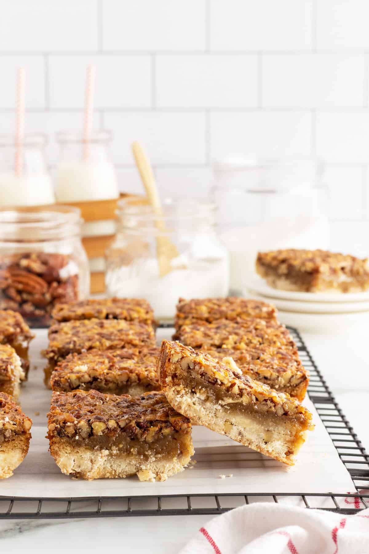 stacked pecan pie bars on a sheet of parchment paper