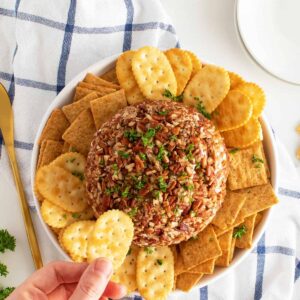 pineapple cheese ball overhead view with srachers aroung the cheese ball
