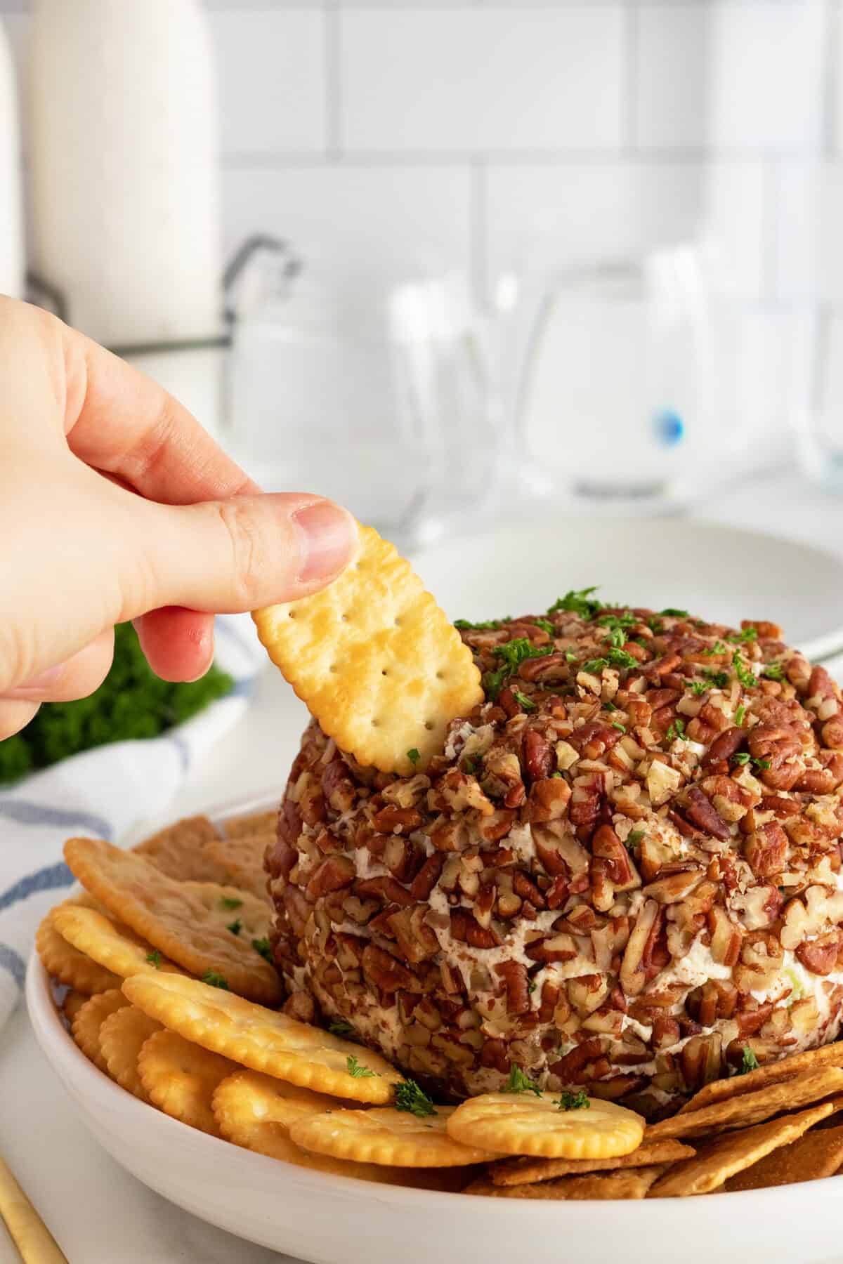 pineapple cheese ball with a cracker scooping out the ball