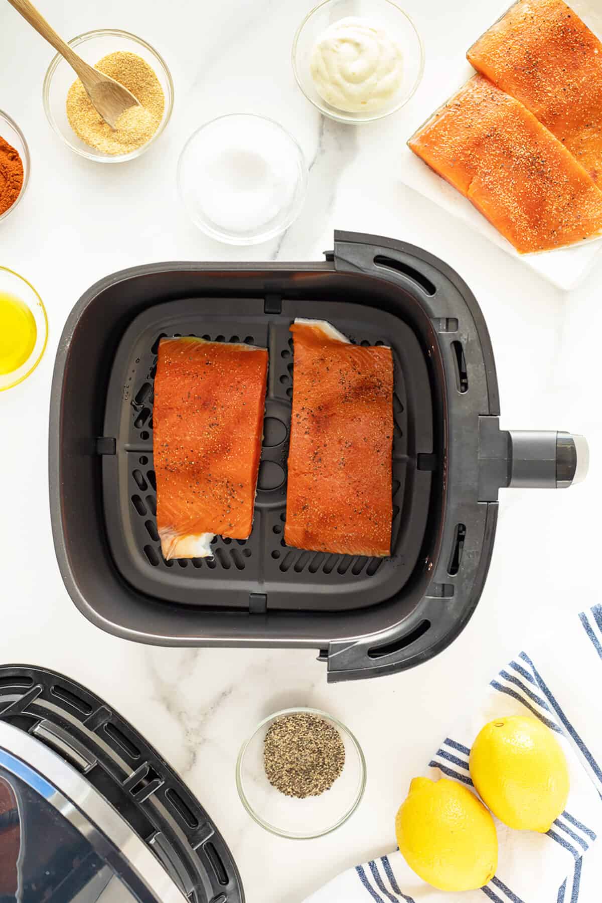 Air fryer salmon in the air fryer basket uncooked