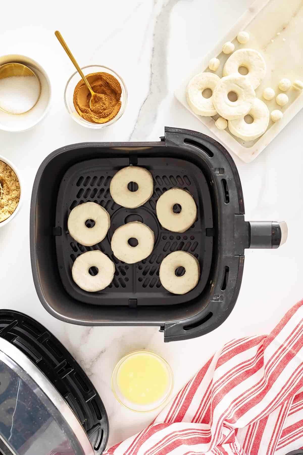 air fryer doughnuts in the air fryer basket ready to be cooked