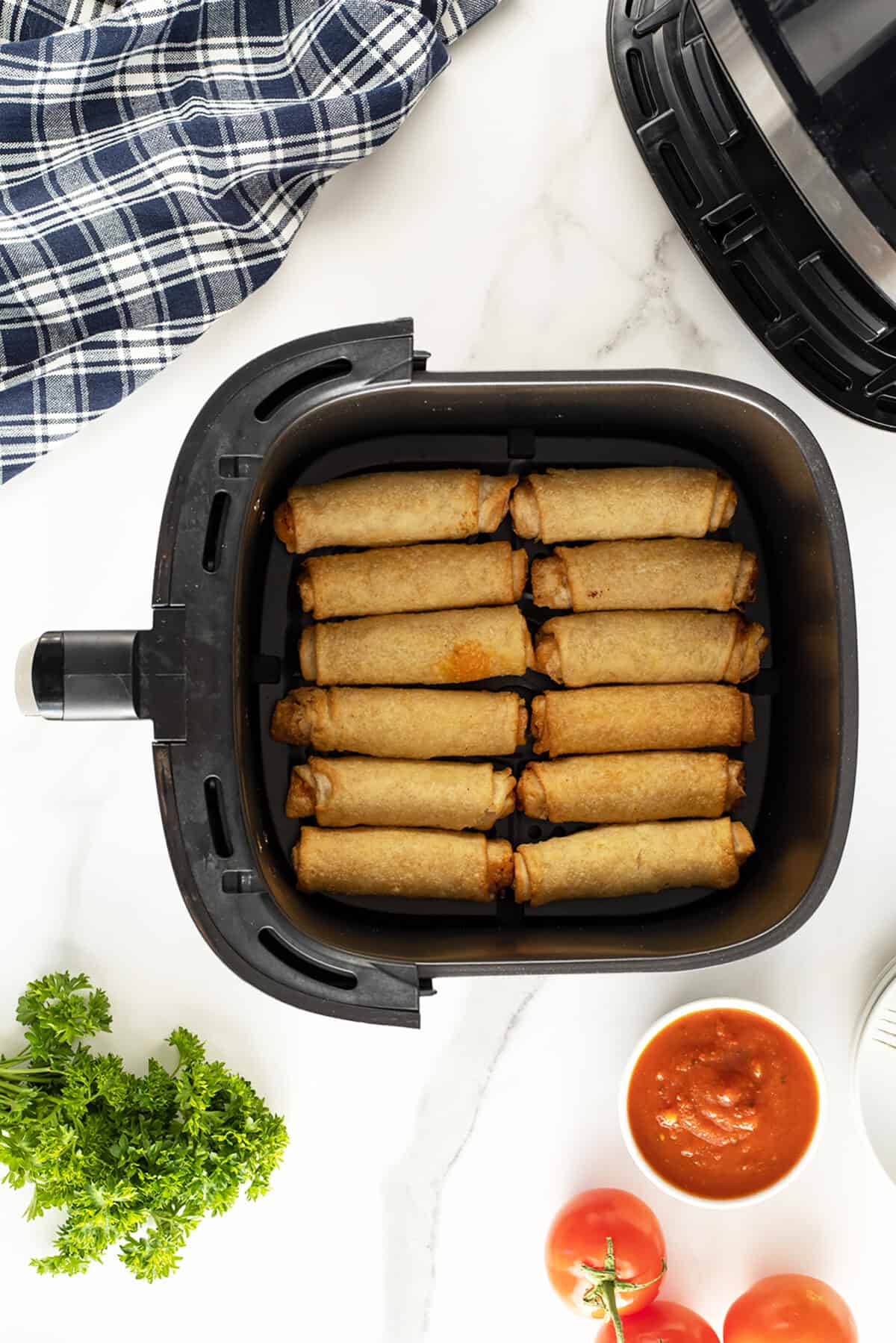 air fryer pizza rolls uncooked in a air fryer basket