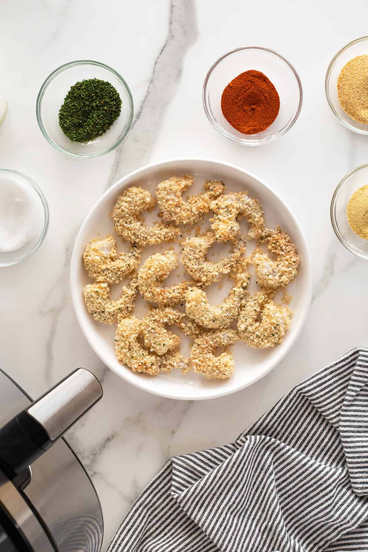 air fryer popcorn shrimp ready to cook on a plate