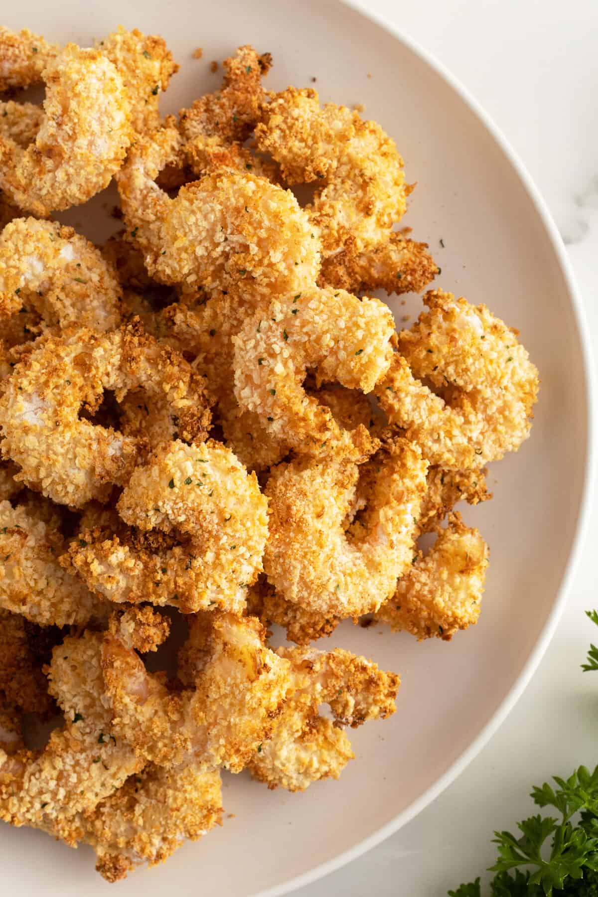 air fryer popcorn shrimp piled on a plate