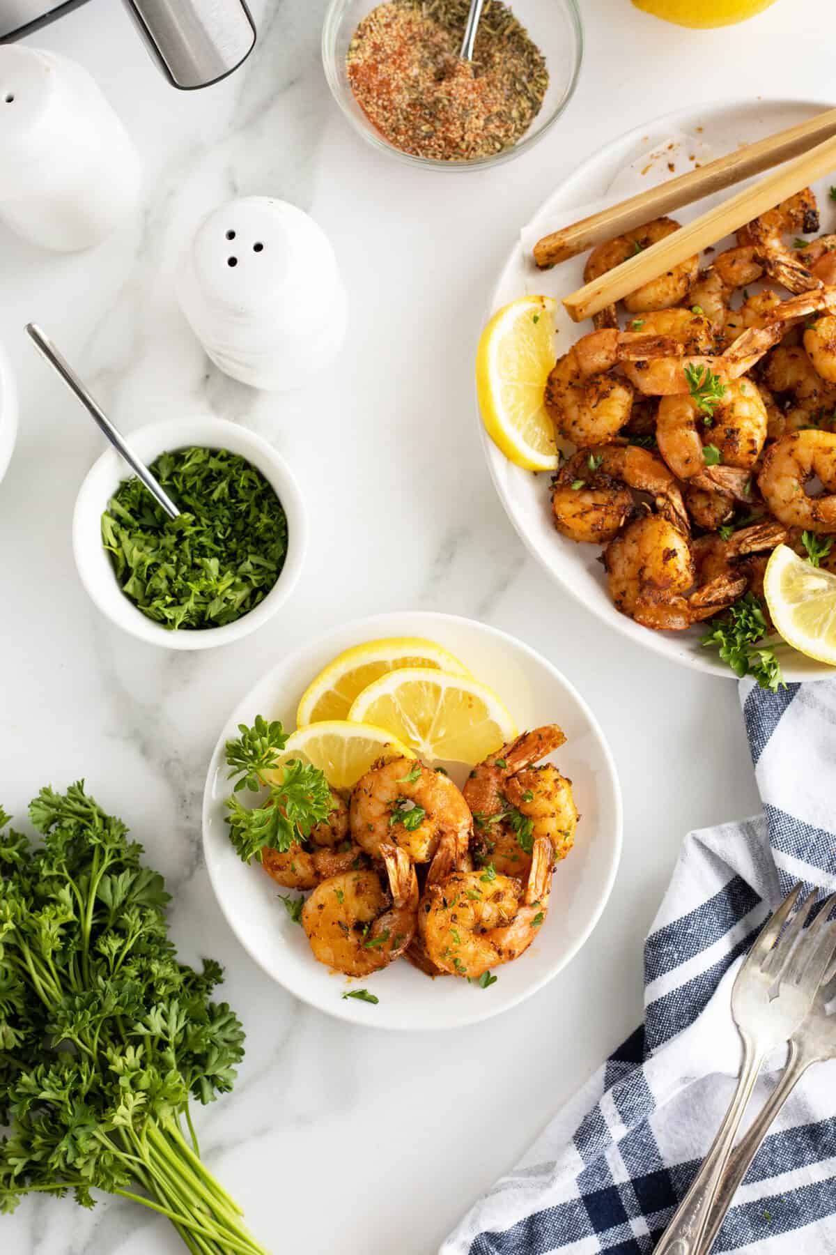 Air fryer shrimp overhead view of a large platter with shrimp and a small plate with shrimp