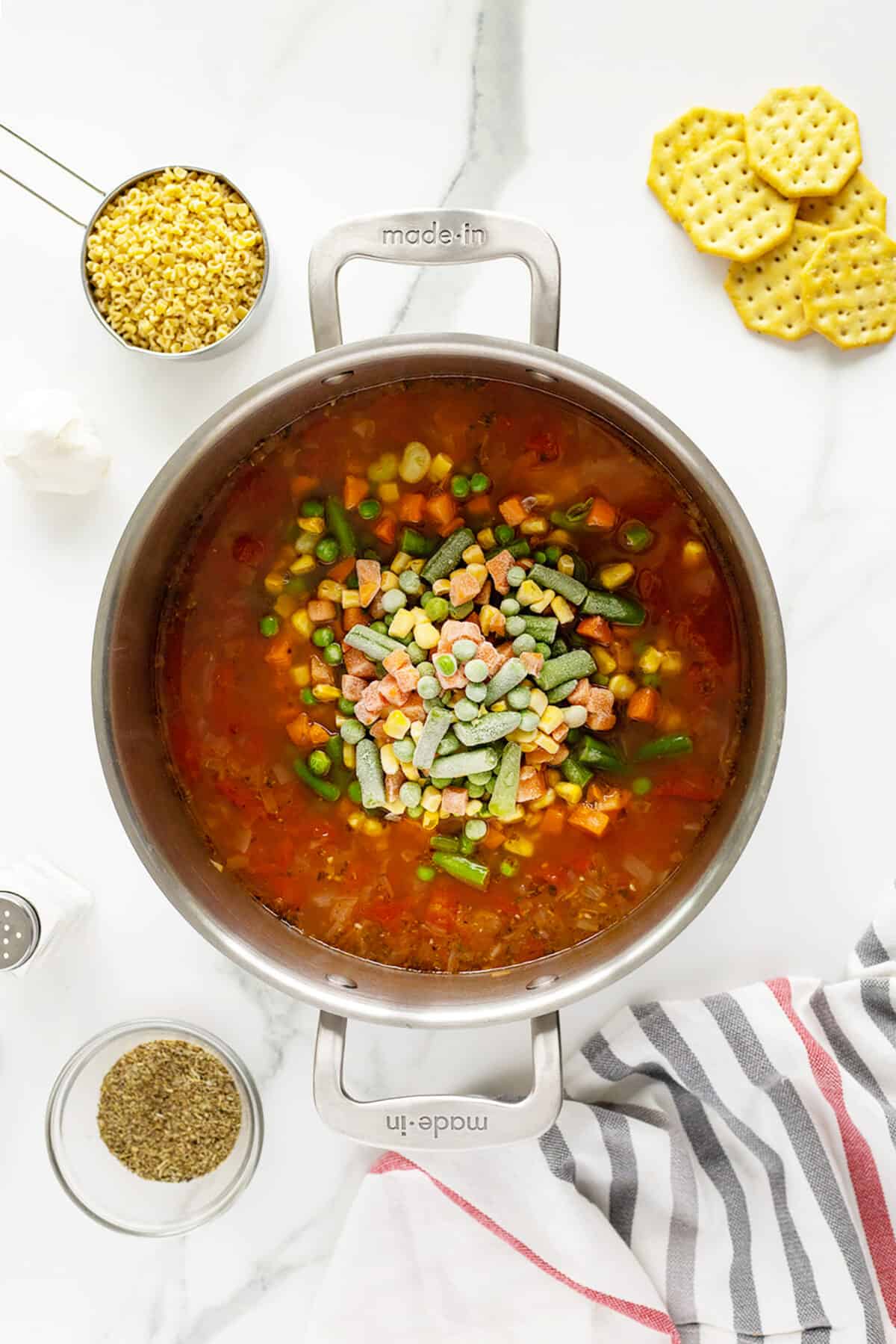alphabet soup adding frozen vegetables to the pot