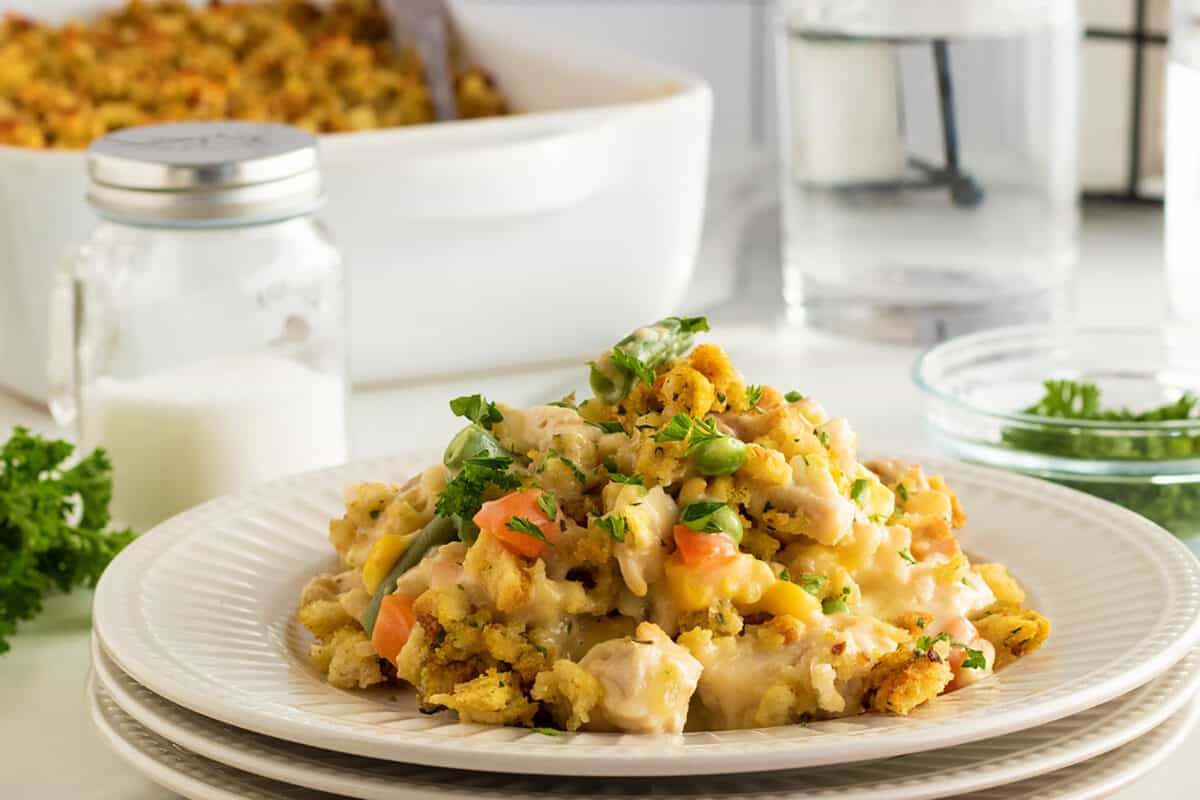 Chicken and stuffing casserole on a stack of white plates
