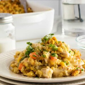 Chicken and stuffing casserole on a stack of white plates