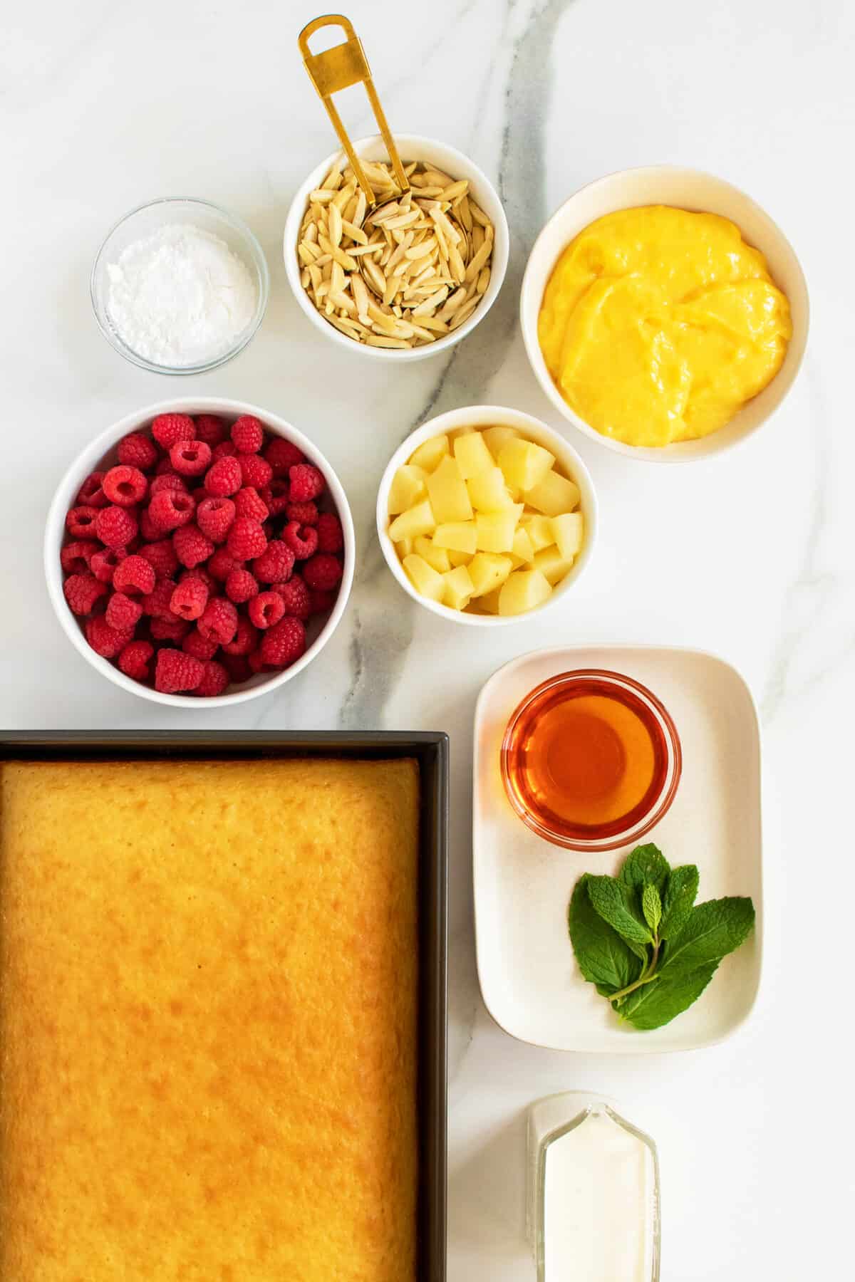 english trifle ingredients in white bowls