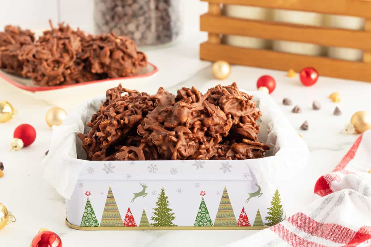 haystack cookies in a festive cookie tin with christmas trees