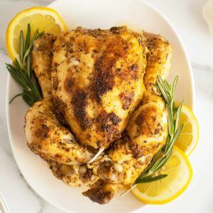 Instant Pot Whole Chicken overhead view with roasemary and lemon slices around