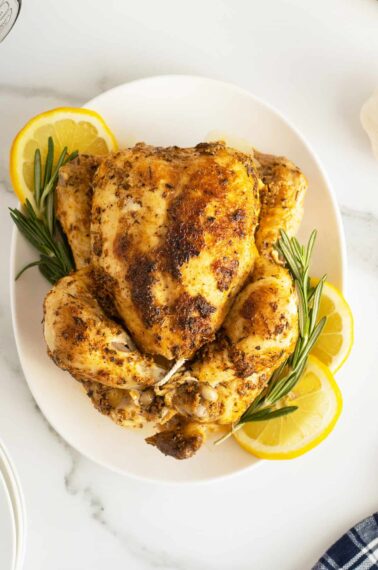 Instant Pot Whole Chicken overhead view with roasemary and lemon slices around