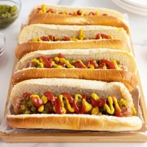 airfryerhotdogs lined up on a cutting board with ketchup and mustard