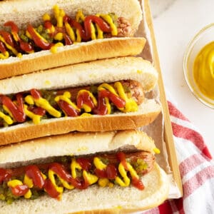 airfryer hot dogs lined up loaded with ketchiup and mustard