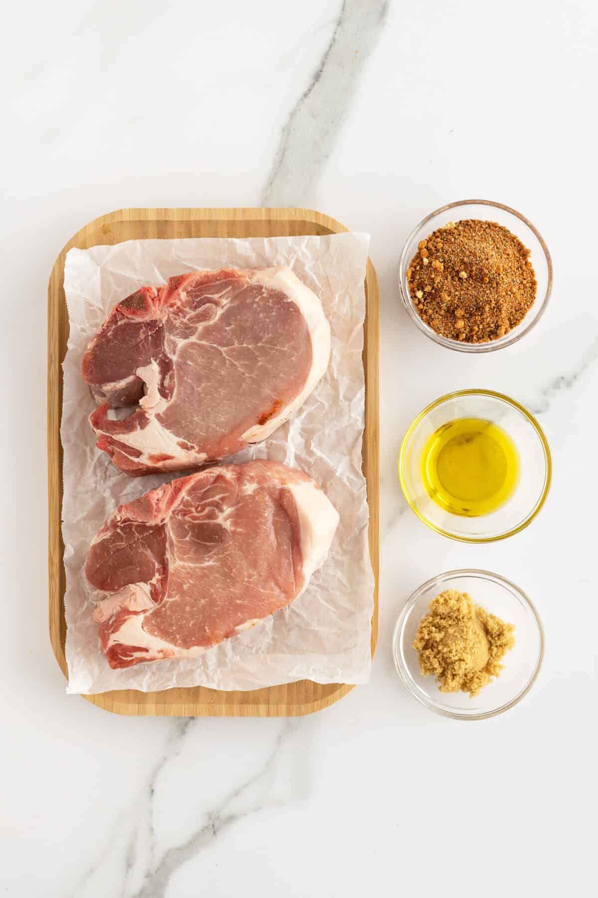 air fryer pork chops ingredients in small clear bowls 