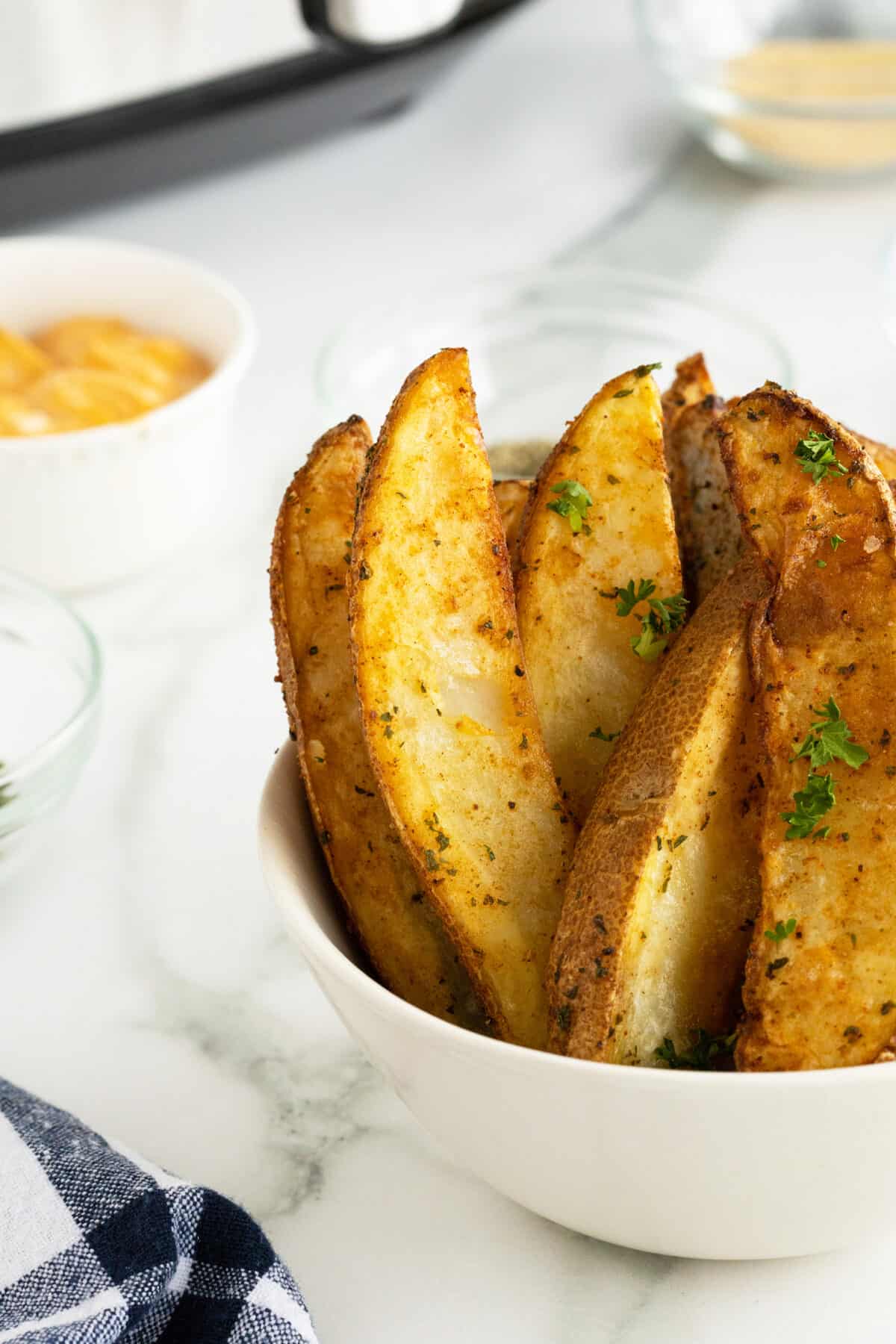 air fryer potato wedges standing up in a bowl