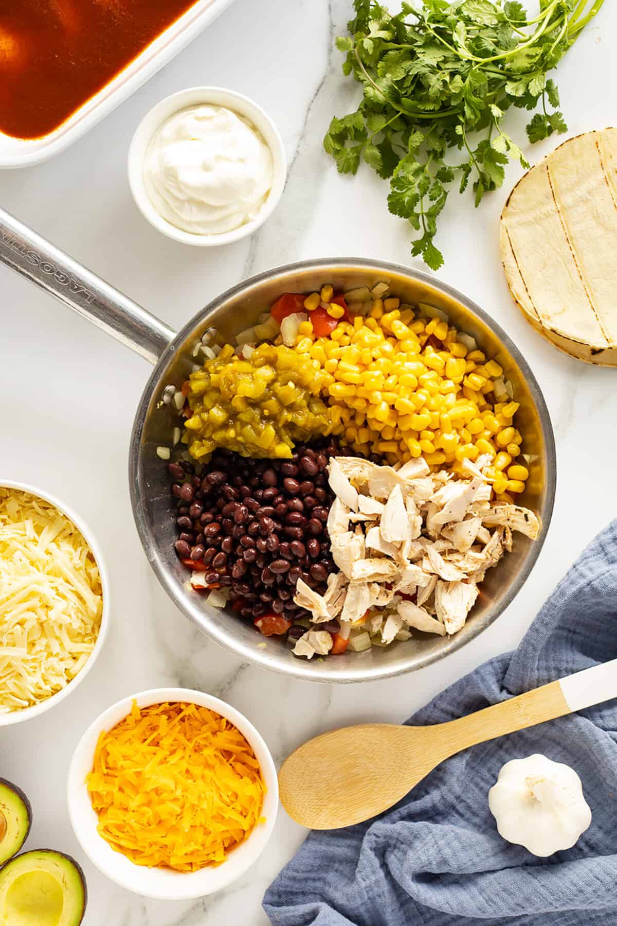 Chicken Enchilada Casserole ingredients in pan separated