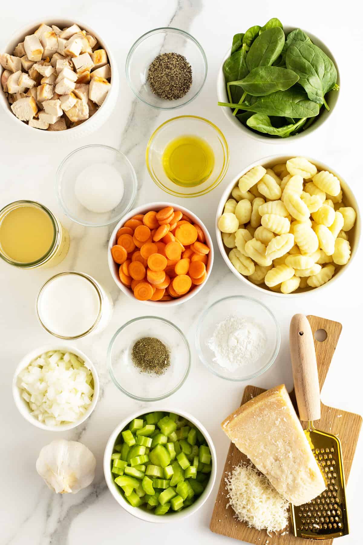 chicken gnocchi soup ingredients in medium white bowls