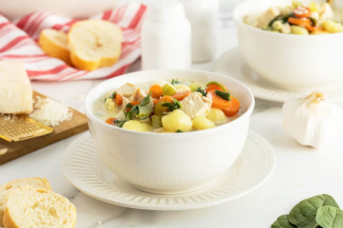 chicken gnocchi soup in a large white bowl 