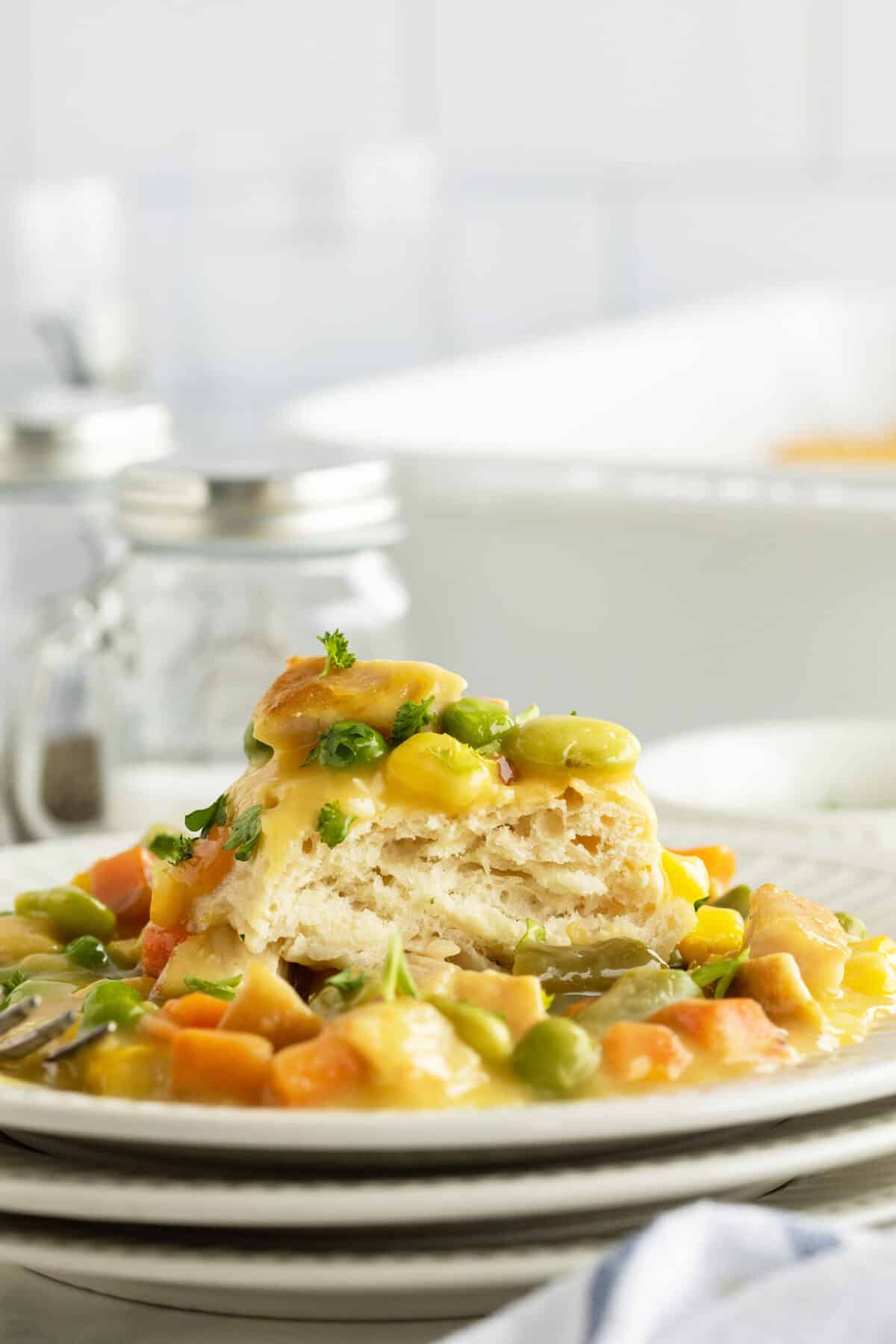 chicken pot pie casserole on a stack of 3 white dishes