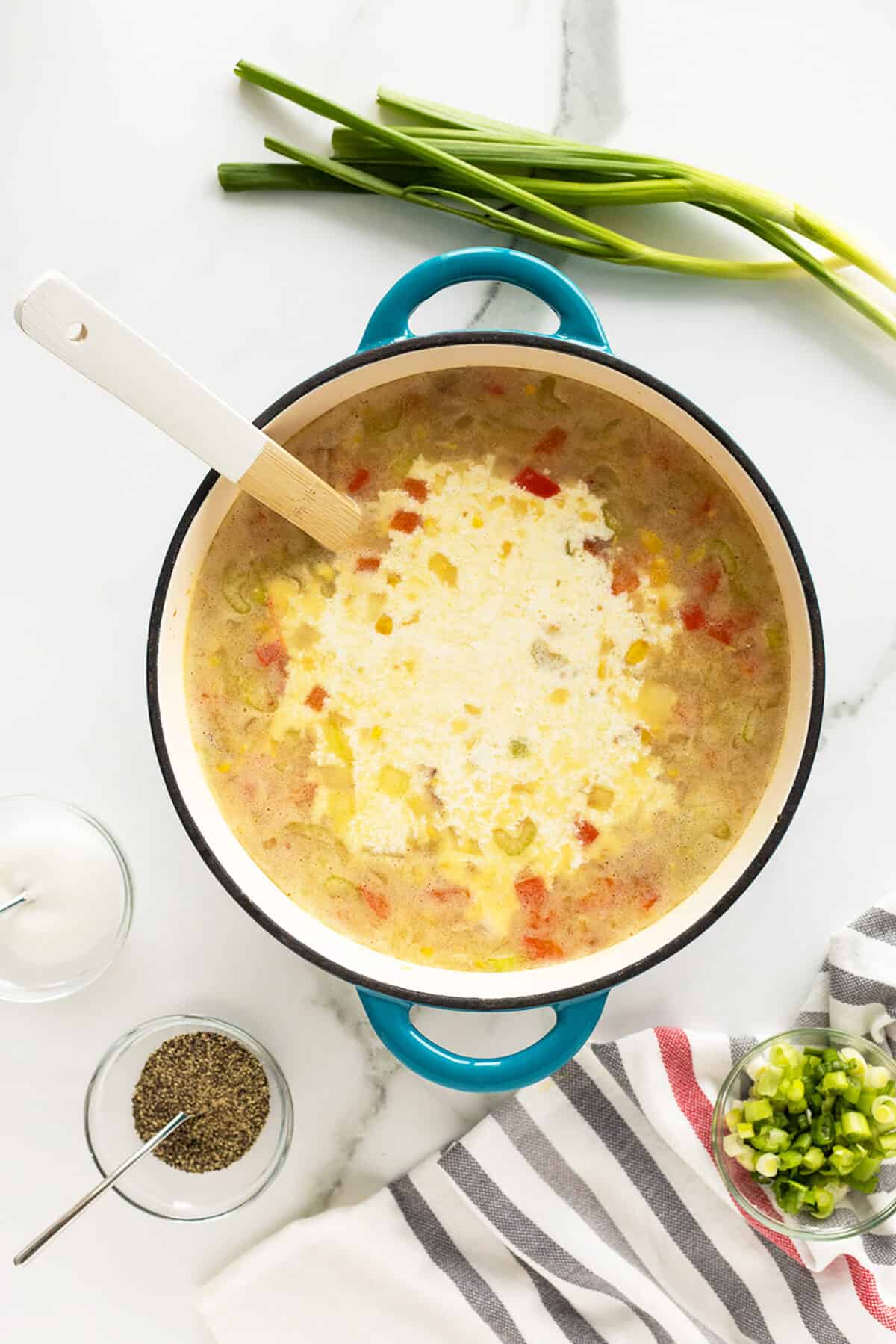 corn chowder with cream poured in the pot