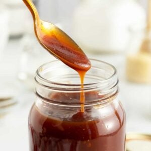 Homemade BBQ Sauce in a jar with a spoon dripping sauce