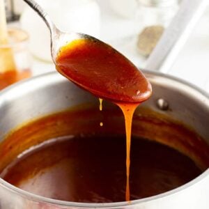 Homemade BBQ Sauce on a spoon dripping into the pot
